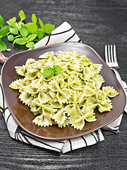 Image showing Farfalle with pesto in plate on black board