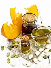 Image showing Oil pumpkin in vial on burlap