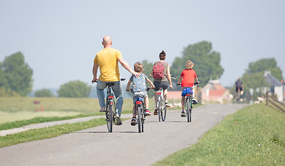 Image showing Cyclists cycling on a dyke