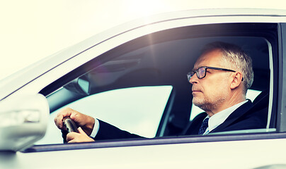 Image showing happy senior businessman driving car