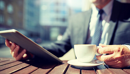 Image showing senior businessman with tablet pc and coffee