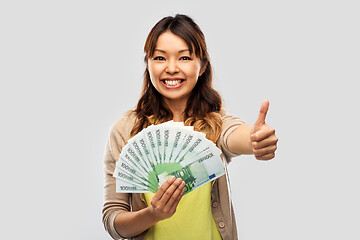 Image showing asian woman with euro money showing thumbs up