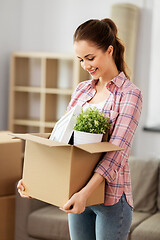 Image showing happy woman with stuff moving to new home