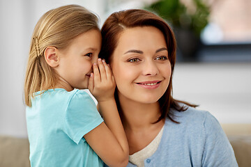 Image showing daughter whispering secret to mother at home