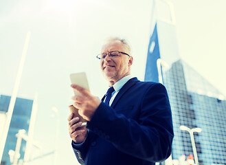 Image showing businessman with smartphone and coffee in city