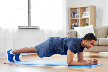 Image showing man doing plank exercise at home