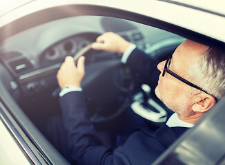 Image showing happy senior businessman driving car