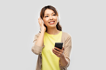 Image showing asian woman in headphones listening to music