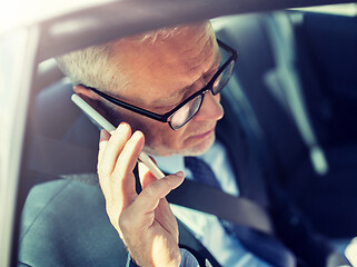 Image showing senior businessman calling on smartphone in car