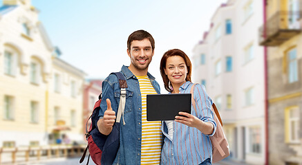 Image showing couple of tourists with tablet computer in city