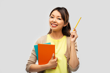 Image showing asian student woman with books and pencil