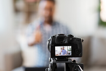 Image showing camera recording video blogger showing thumbs up