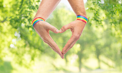 Image showing male hands with gay pride wristbands showing heart