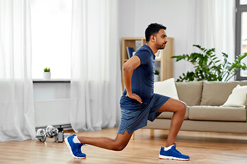 Image showing indian man exercising and doing lunge at home