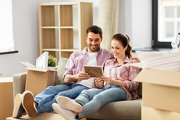 Image showing happy couple with boxes moving to new home