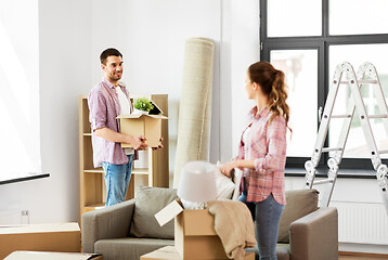 Image showing happy couple with stuff moving to new home