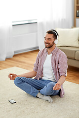 Image showing man in headphones meditating listening to music