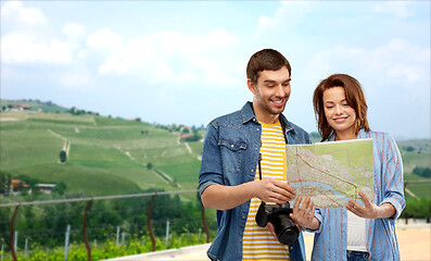 Image showing happy couple of tourists with map and camera