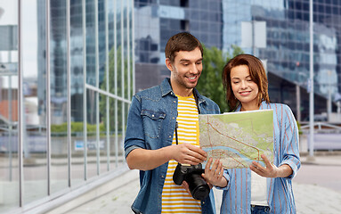 Image showing couple of tourists with map and camera in city