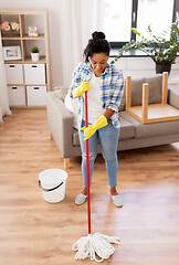 Image showing african woman or housewife cleaning floor at home