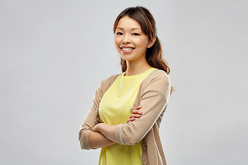 Image showing happy asian woman over grey background