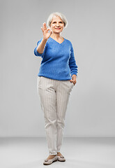 Image showing portrait of smiling senior woman making ok gesture