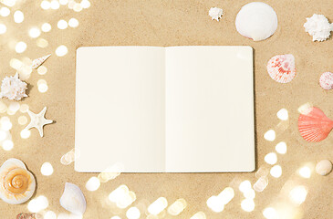 Image showing notebook with seashells on beach sand