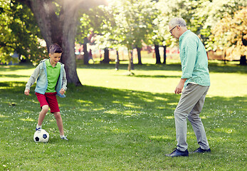 Image showing old man and boy playing football at summer park