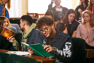 Image showing The group of cheerful happy students sitting in a lecture hall before lesson