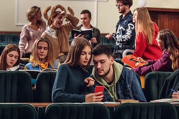 Image showing The group of cheerful happy students sitting in a lecture hall before lesson