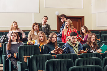 Image showing The group of cheerful happy students sitting in a lecture hall before lesson