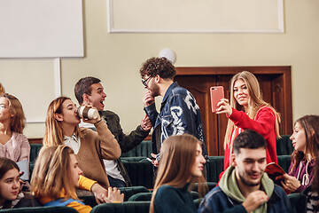 Image showing The group of cheerful happy students sitting in a lecture hall before lesson