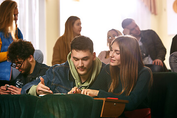 Image showing The group of cheerful happy students sitting in a lecture hall before lesson