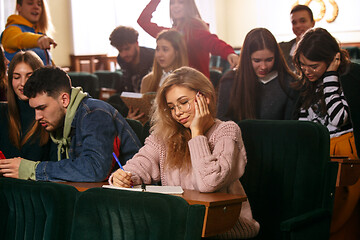 Image showing The group of cheerful happy students sitting in a lecture hall before lesson