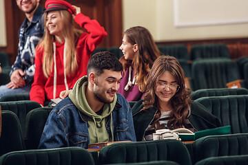 Image showing The group of cheerful happy students sitting in a lecture hall before lesson