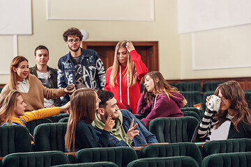 Image showing The group of cheerful happy students sitting in a lecture hall before lesson