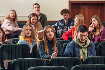 Image showing The group of cheerful happy students sitting in a lecture hall before lesson