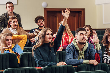 Image showing The group of cheerful happy students sitting in a lecture hall before lesson