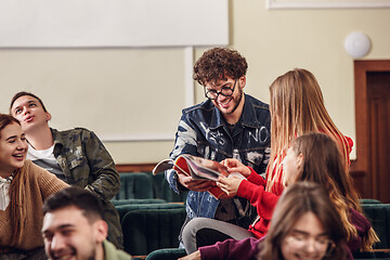 Image showing The group of cheerful happy students sitting in a lecture hall before lesson