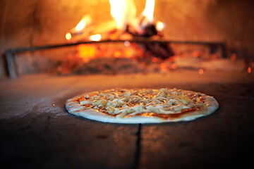 Image showing rustic pizza in wood fired oven