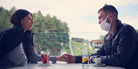 Image showing couple in restaurant wearing corona virus  medical protective fa