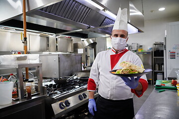 Image showing chef cook wearing face protective medical mask for protection fr