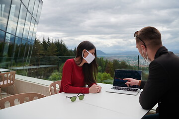 Image showing business people wearing protective mask