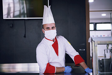 Image showing chef cook wearing face protective medical mask for protection fr