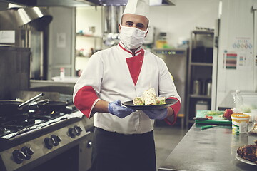 Image showing chef cook wearing face protective medical mask for protection fr