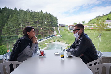 Image showing couple in restaurant wearing corona virus  medical protective fa