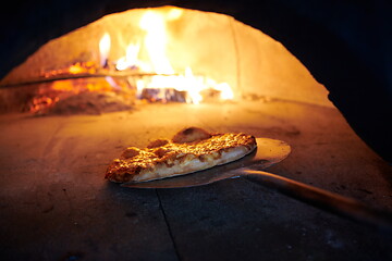 Image showing rustic pizza in wood fired oven