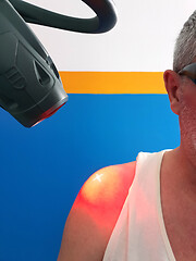 Image showing Physical therapy using a laser to treat an injured shoulder