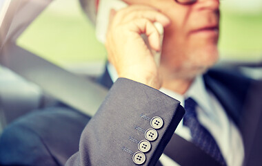 Image showing senior businessman calling on smartphone in car