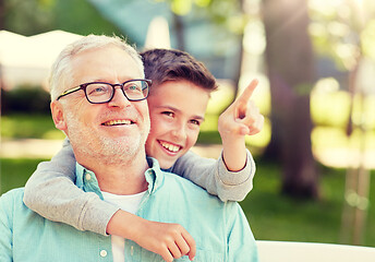 Image showing grandfather and boy pointing finger at summer park